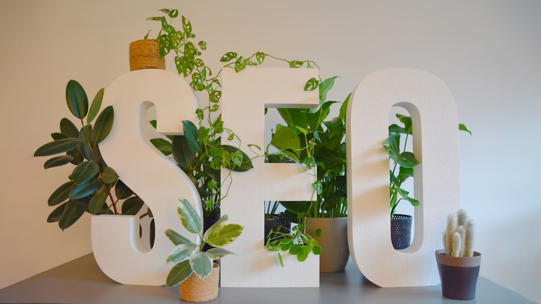 about-us Vibrant and nature-inspired office setting at an SEO agency, featuring large SEO letters prominently displayed on a modern desk. The letters are adorned with an abundance of lush green plants, creating a refreshing and natural atmosphere. The combination of digital focus and greenery brings a unique balance of productivity and tranquility to the workspace.